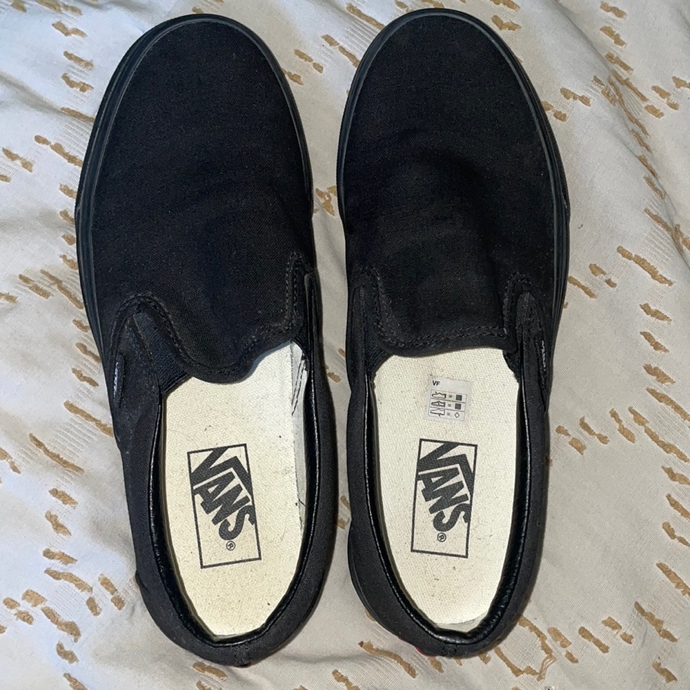 Black low top slip-on Vans